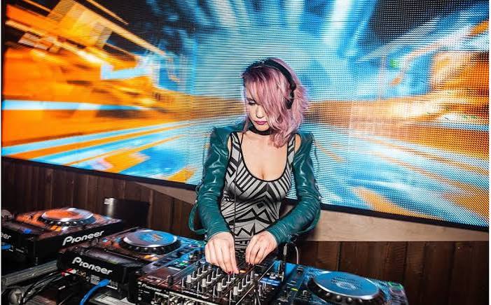 DJ performing in front of a large LED video wall